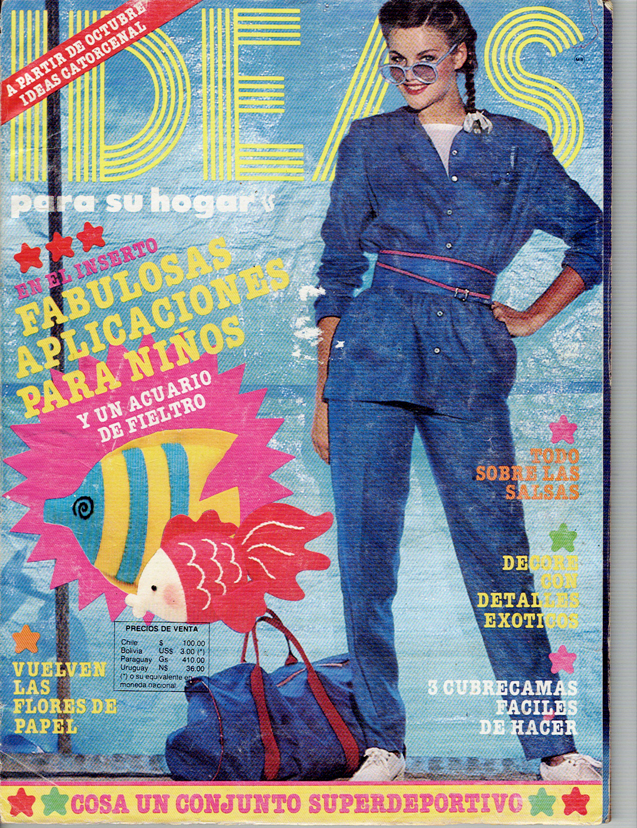 Portada de Revista Ideas, edición de Septiembre de 1981. De cuerpo completo una modelo posa con una mano en la cintura un conjunto deportivo color azul. También en portada aparecen dos peces hechos en fieltro de colores amarillo azul y rosa rojo.